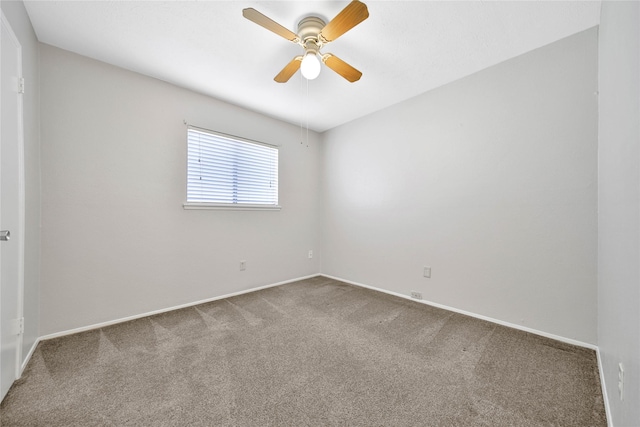 spare room featuring carpet flooring and ceiling fan