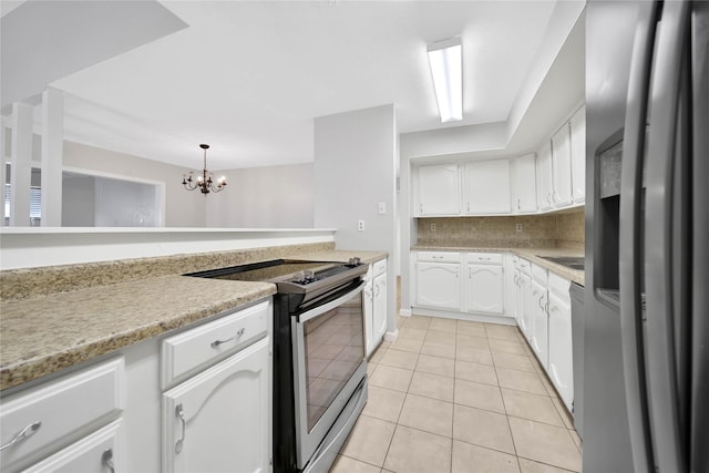 kitchen featuring light tile patterned floors, a notable chandelier, pendant lighting, white cabinets, and appliances with stainless steel finishes