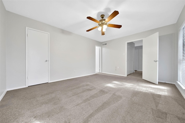 unfurnished bedroom featuring light carpet and ceiling fan