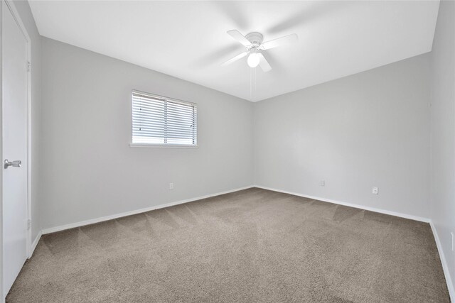 carpeted empty room with ceiling fan