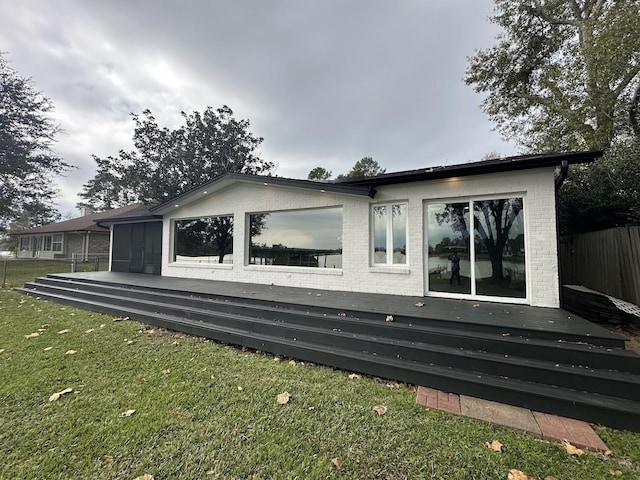 view of side of property with a lawn