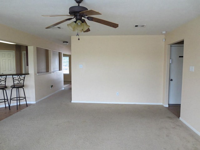 carpeted empty room featuring ceiling fan