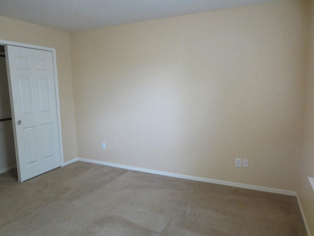 unfurnished room with light carpet