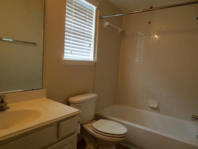 full bathroom with vanity, tiled shower / bath combo, and toilet