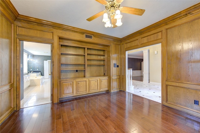 unfurnished living room with dark hardwood / wood-style floors, ceiling fan, built in features, and crown molding