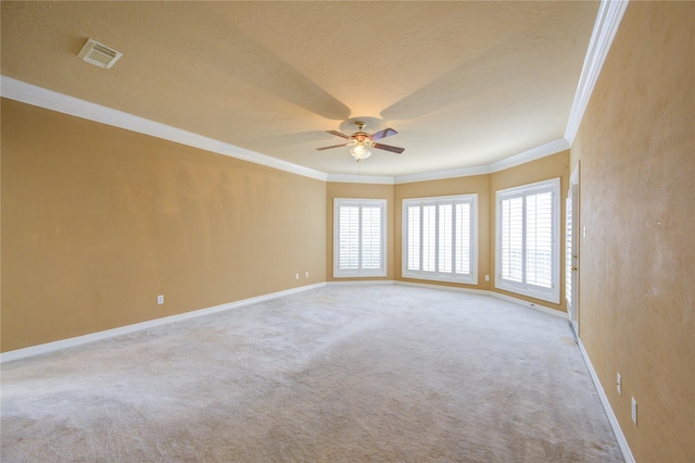 carpeted empty room featuring ceiling fan and ornamental molding