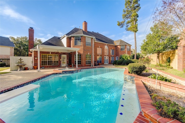 view of swimming pool featuring an in ground hot tub, ceiling fan, and a patio area