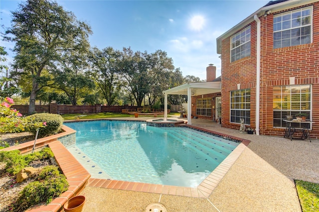 view of swimming pool featuring an in ground hot tub and a patio