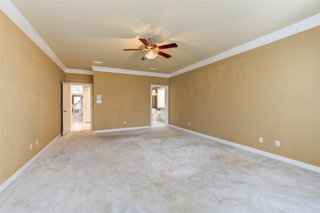 empty room featuring ceiling fan, crown molding, and light carpet