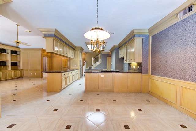 kitchen featuring ceiling fan with notable chandelier, light brown cabinets, kitchen peninsula, and hanging light fixtures