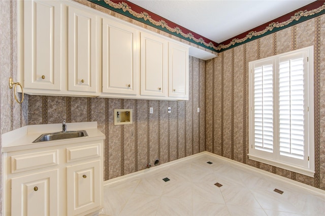 clothes washing area featuring cabinets, washer hookup, light tile patterned flooring, and sink