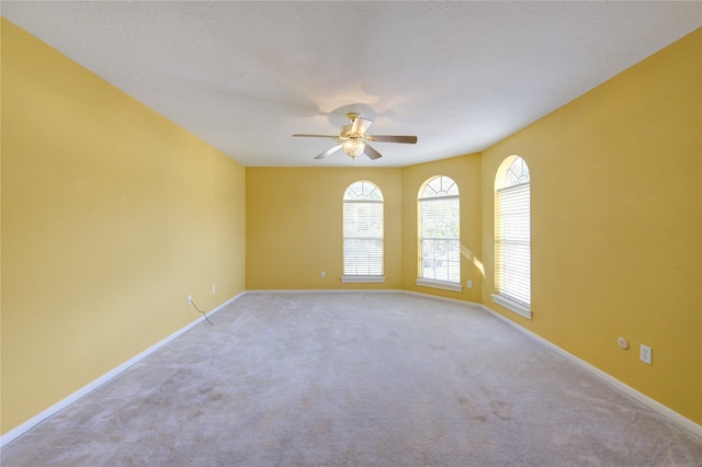 spare room with light carpet and ceiling fan