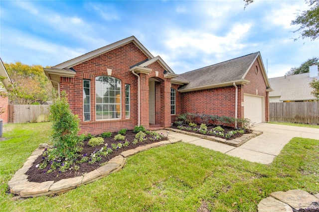 view of front of house with a garage and a front lawn