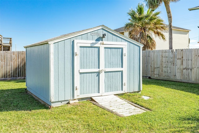 view of outbuilding featuring a lawn