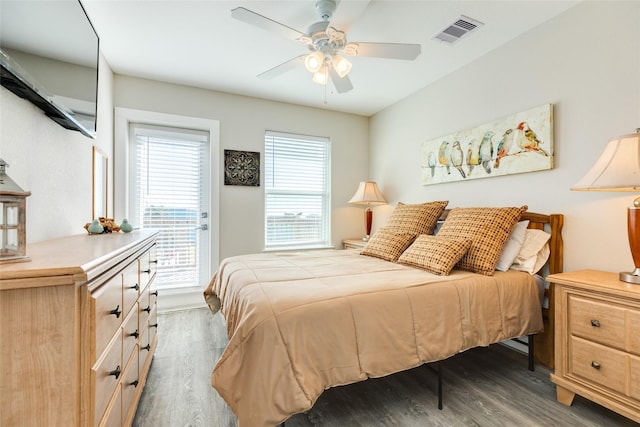 bedroom with ceiling fan and dark hardwood / wood-style floors