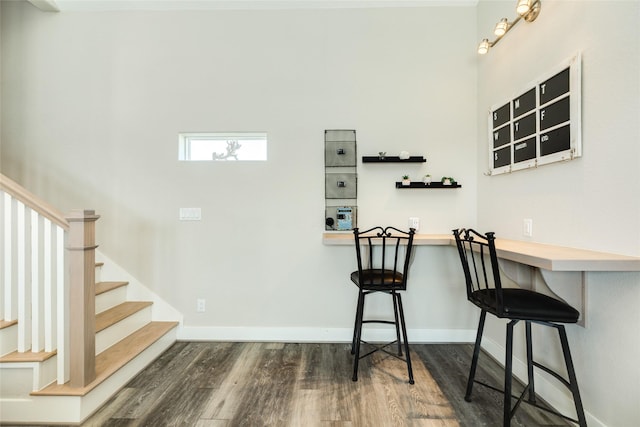 bar featuring dark wood-type flooring