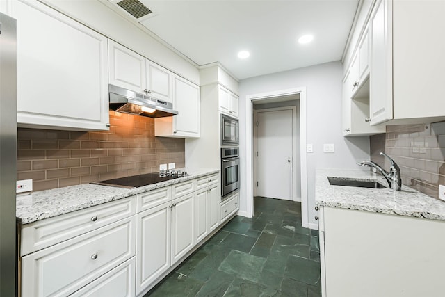 kitchen featuring white cabinetry, sink, black electric cooktop, and oven