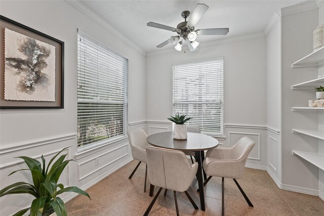 dining space featuring ceiling fan and crown molding