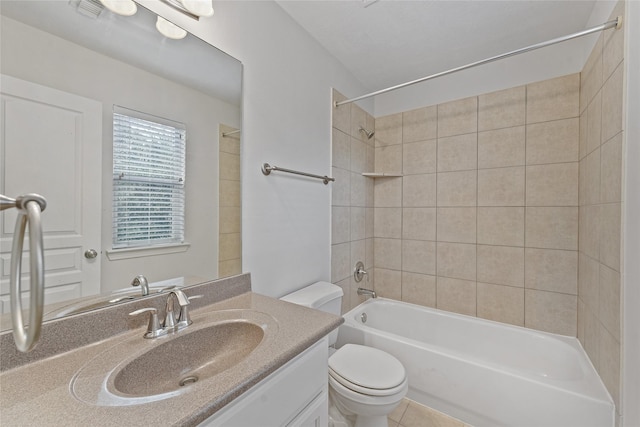 full bathroom featuring tile patterned flooring, tiled shower / bath combo, toilet, and vanity