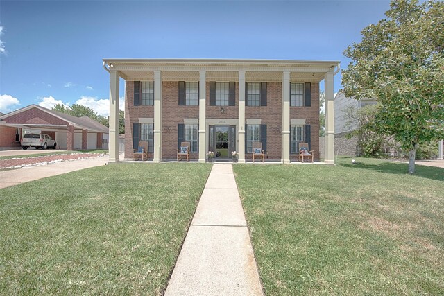 neoclassical home featuring a front yard