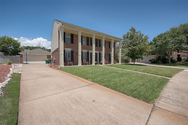 view of front of property featuring a front yard and a balcony