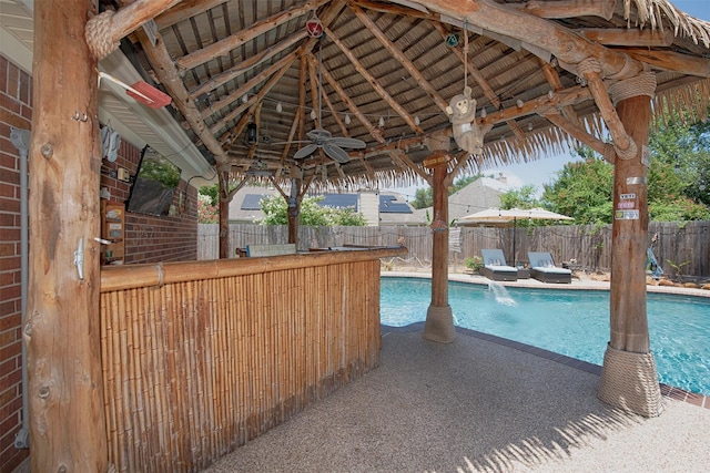 view of pool featuring a gazebo and ceiling fan