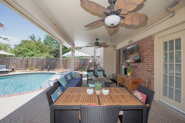 view of patio / terrace with a fenced in pool, outdoor lounge area, and ceiling fan