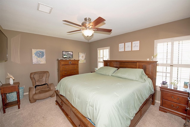 bedroom with ceiling fan and light colored carpet