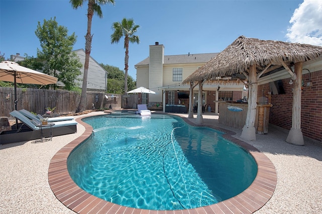 view of swimming pool featuring a patio and an outdoor bar