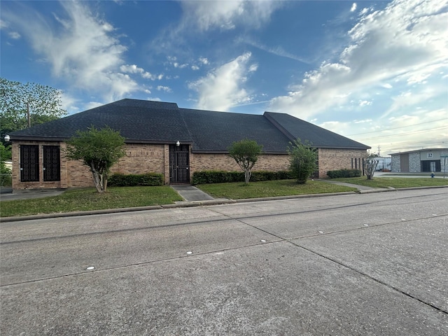 7555 Morley St, Houston, TX 77061 - view of front of home featuring roof with shingles and brick siding