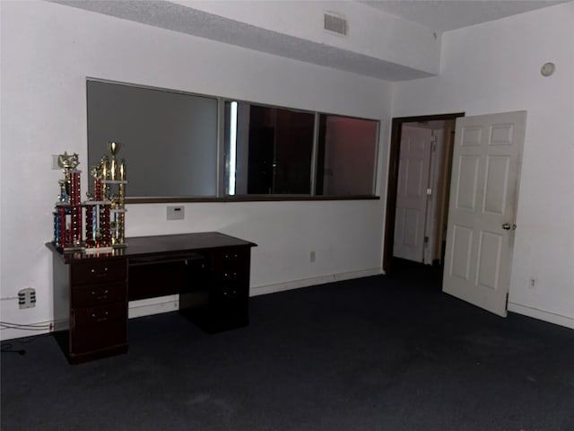 7555 Morley St, Houston, TX 77061 - interior space with dark carpet, visible vents, and baseboards