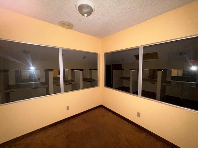 7555 Morley St, Houston, TX 77061 - unfurnished room with a textured ceiling, carpet floors, and baseboards
