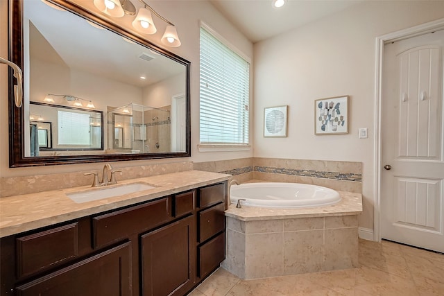 bathroom with tile patterned flooring, vanity, and separate shower and tub