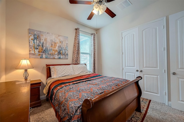 carpeted bedroom featuring a closet and ceiling fan