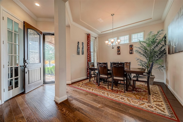 dining space with dark hardwood / wood-style flooring and a notable chandelier