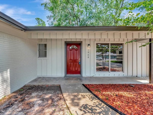 view of exterior entry with covered porch