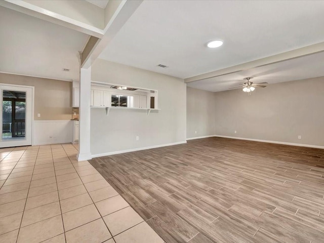 unfurnished living room featuring light wood-type flooring and ceiling fan