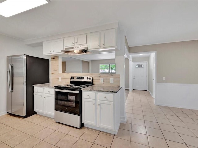 kitchen with backsplash, white cabinets, light stone countertops, light tile patterned floors, and stainless steel appliances