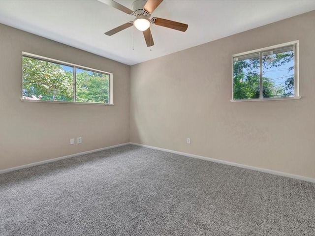 spare room featuring carpet and ceiling fan