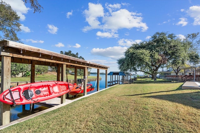 view of dock featuring a lawn and a water view