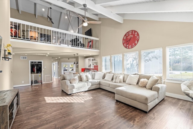 living room with beam ceiling, dark hardwood / wood-style floors, high vaulted ceiling, and ceiling fan