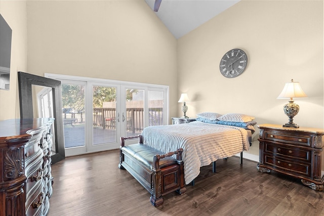 bedroom with high vaulted ceiling, dark hardwood / wood-style flooring, and access to outside