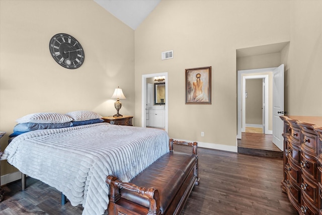 bedroom featuring ensuite bathroom, vaulted ceiling, and dark wood-type flooring