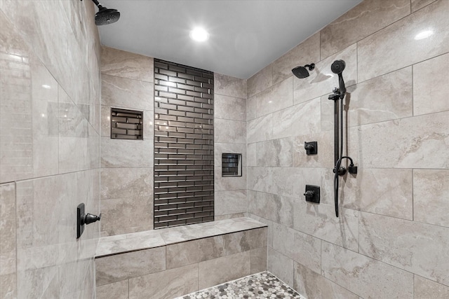 bathroom with a tile shower