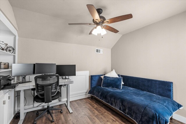 office space featuring dark hardwood / wood-style floors, vaulted ceiling, and ceiling fan