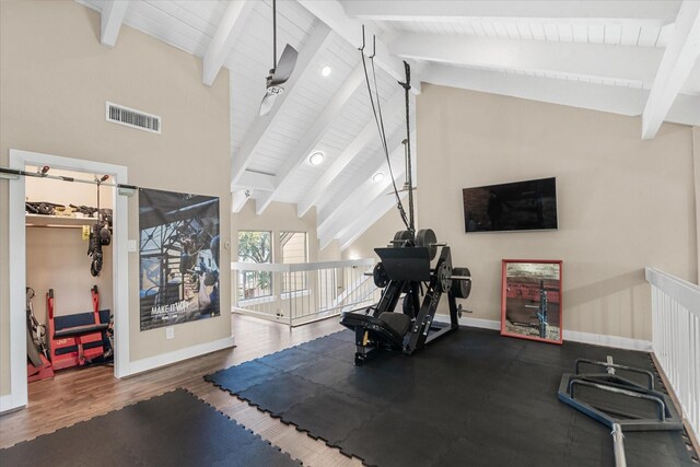 workout room with ceiling fan, lofted ceiling, and dark wood-type flooring