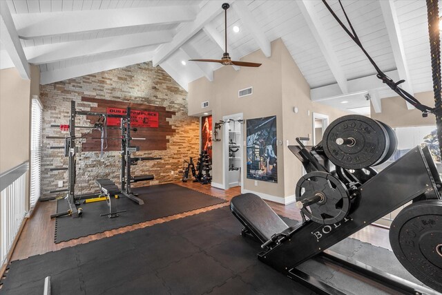 workout room with hardwood / wood-style floors, ceiling fan, and high vaulted ceiling