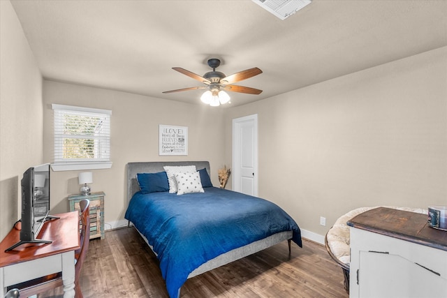 bedroom with ceiling fan and dark wood-type flooring