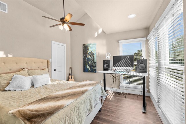 bedroom featuring hardwood / wood-style flooring, ceiling fan, and lofted ceiling