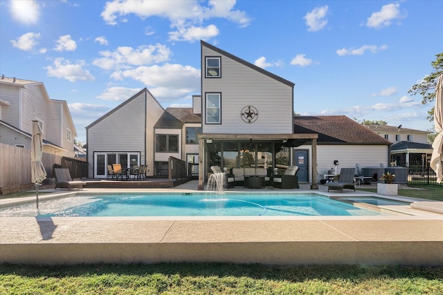 view of swimming pool with a jacuzzi, pool water feature, an outdoor living space, and a patio